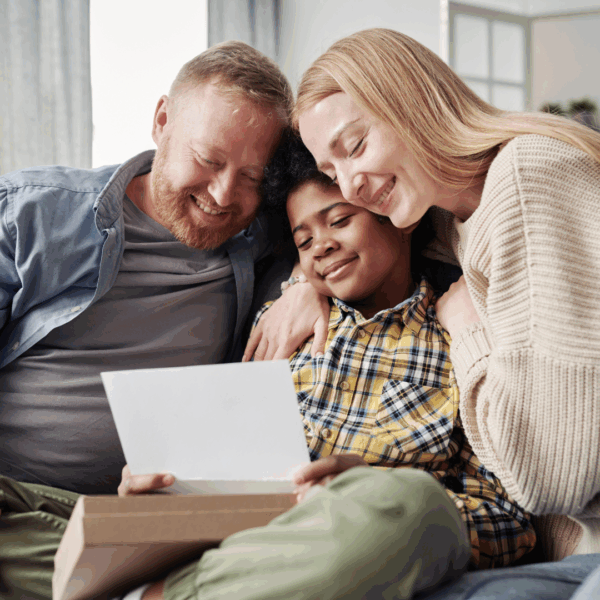 Adoptive parents with child reading a letter
